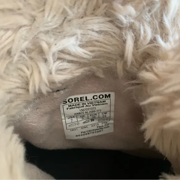 Sorel tan and black furry short snow boots size 7
